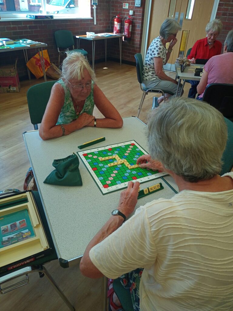 Image of two members playing scrabble